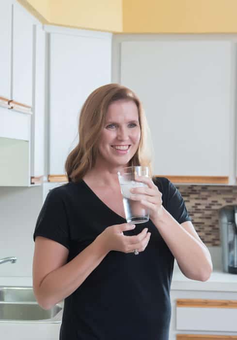 Water Treatment Company | Woman holding a glass of water