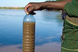 A Plastic Bottle With Brown Water | Dirty Water